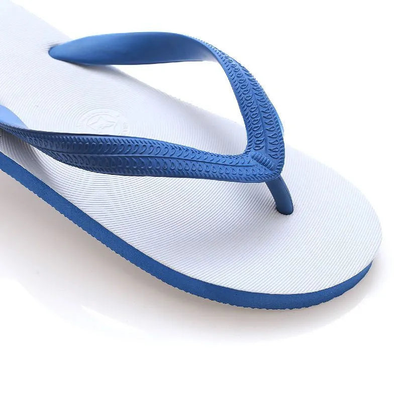Green rubber flip-flop with fish label design, showing textured non-slip sole.