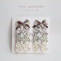 Set of children's fabric hairclips with dovetail bows in eight different colours and patterns.