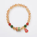 Hand-woven citrine five sutra bracelet with 6mm crystal beads showing geometric patterns
