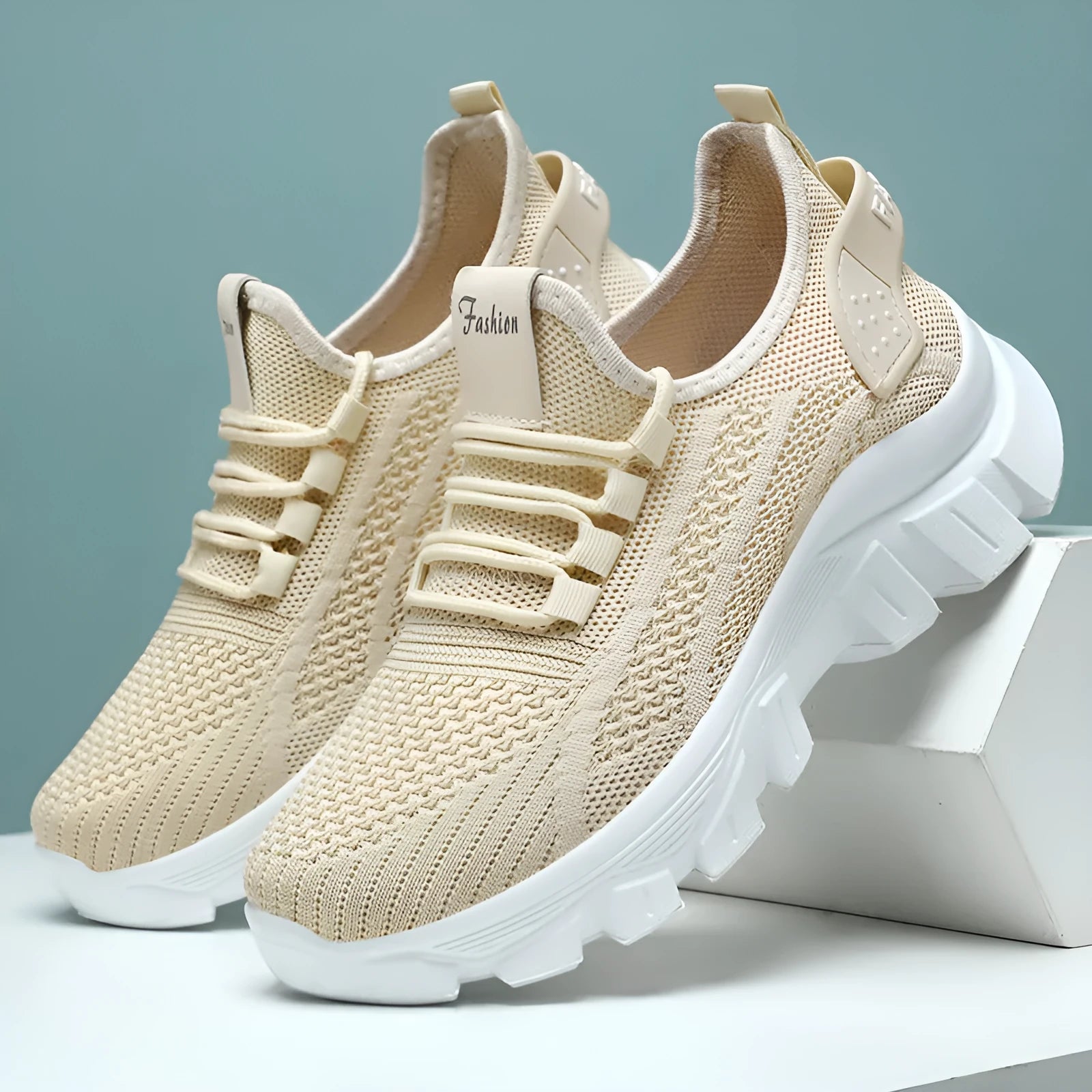 Women's white Flyknit sneakers with thick PVC sole and lace-up design on a neutral background.