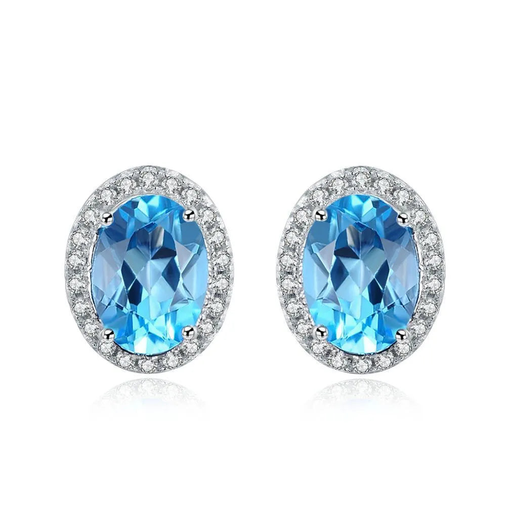 925 sterling silver jewellery set with blue topaz gems showing geometric patterned necklace, earrings, ring and pendant