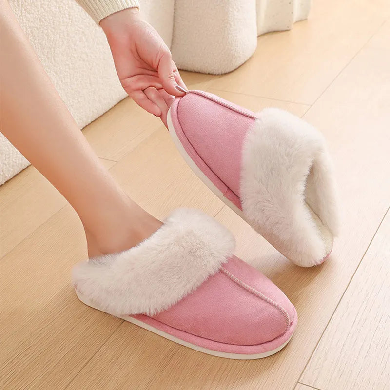 Brown plush indoor slippers with round toe, decorative stitching, and a light-coloured anti-slip sole.