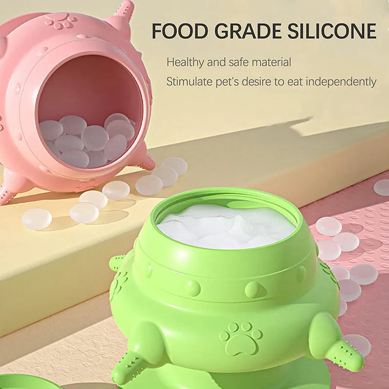 Pink silicone pet nursing milk feeder bowl with four pacifiers on a flat base.