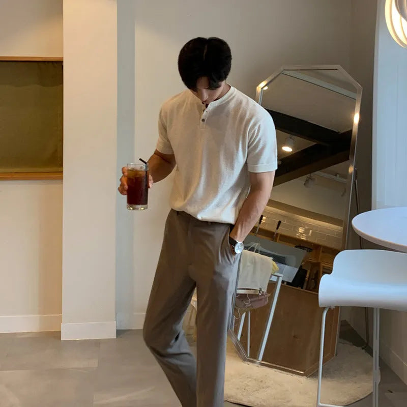 Man wearing a slim-fit black short-sleeved ice silk knitted shirt.