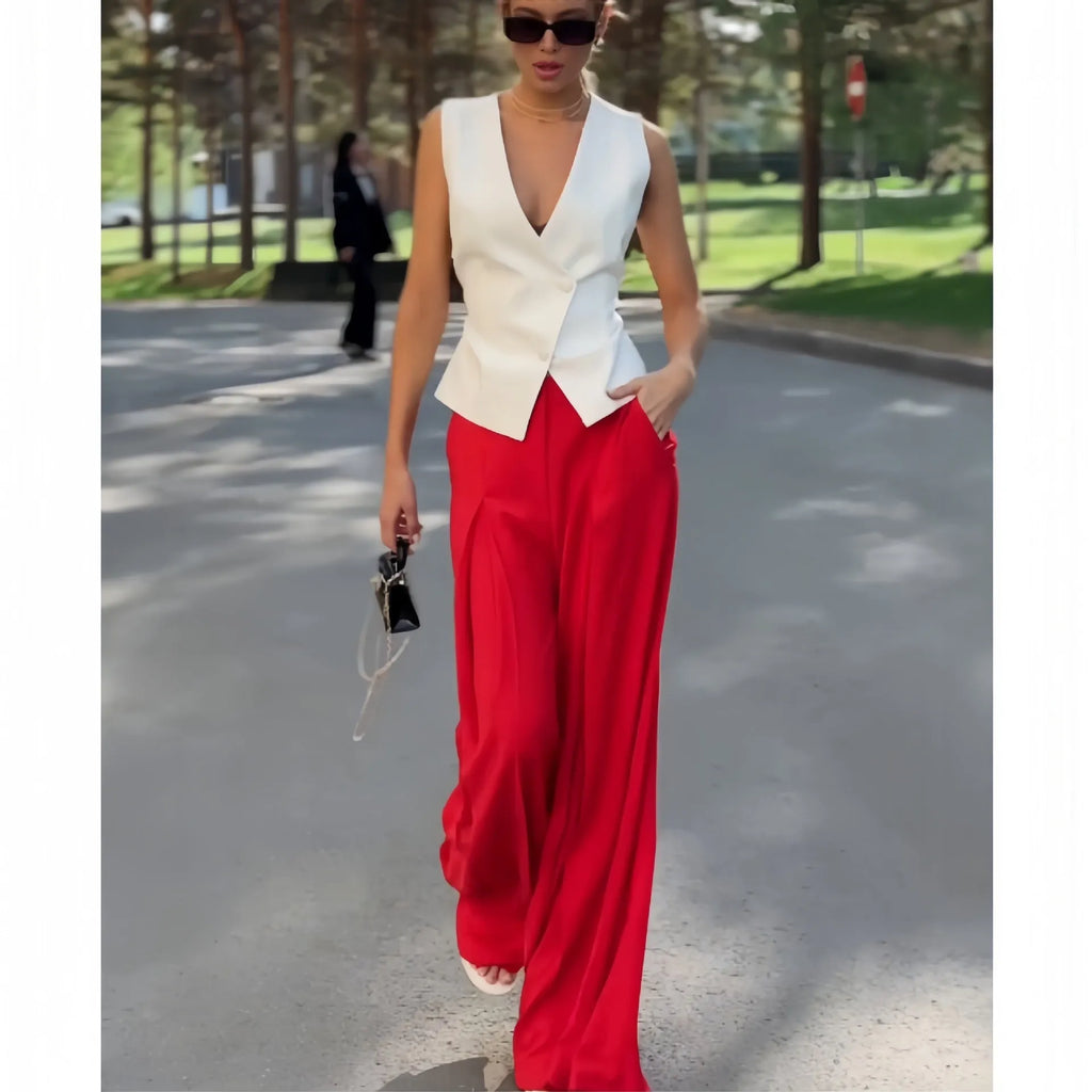 Women's beige two-piece set featuring a sleeveless deep V-neck top and high-waist wide-leg trousers.