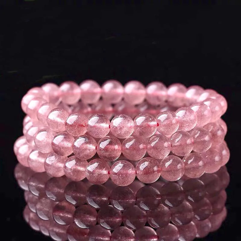 Women's strawberry quartz bracelet with polished beads in 6mm, 8mm, or 10mm sizes.