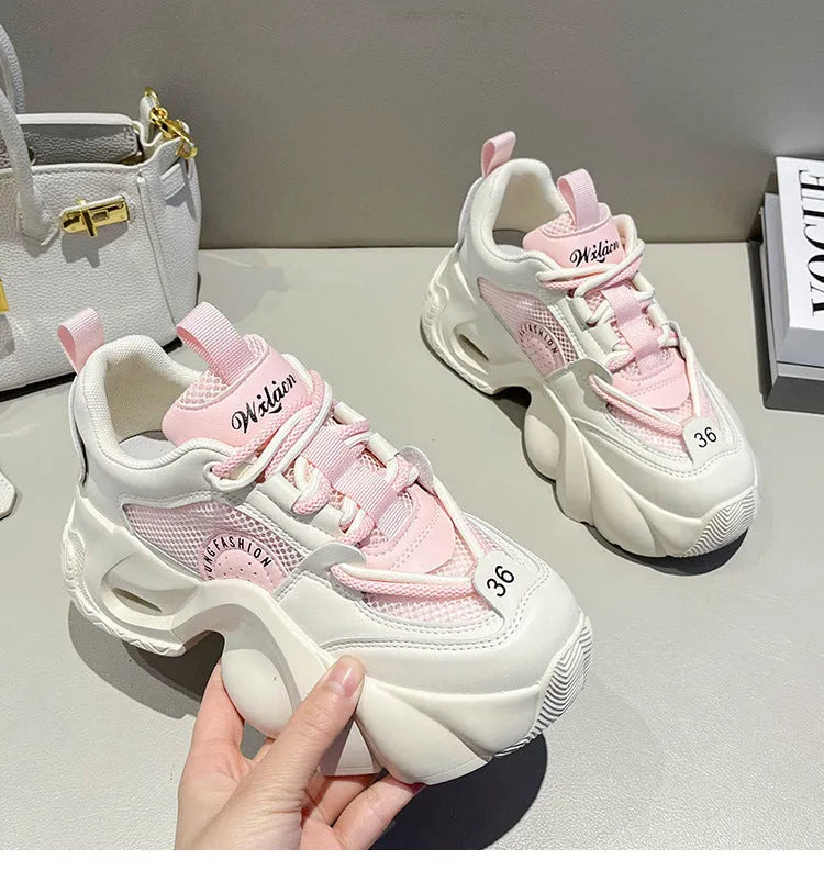 Women's beige sneakers with thick sole, cross straps, and mesh lining.
