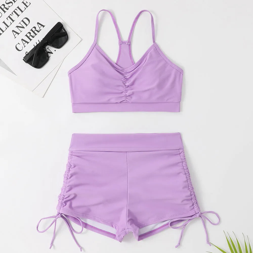 Women's black high waist split bikini swimsuit top and shorts laid flat.