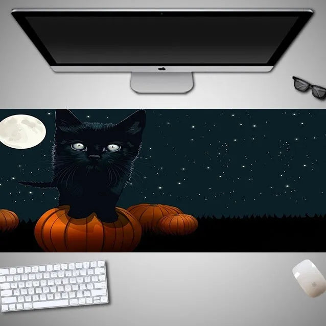 Oversized Halloween-themed gaming mouse pad with non-slip base on a desk.