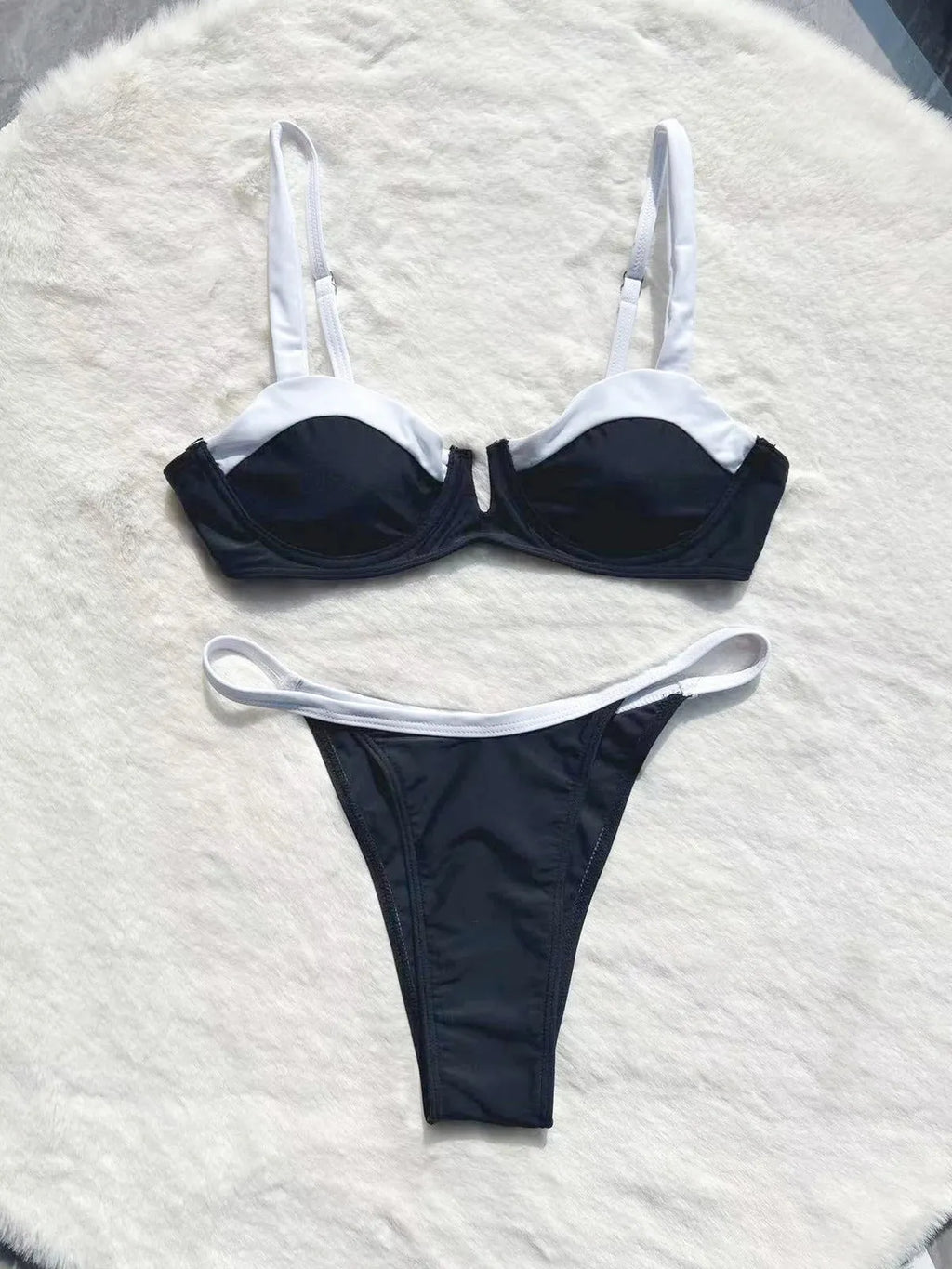 Black low waist women's bikini swimsuit with stitching detail and split briefs design