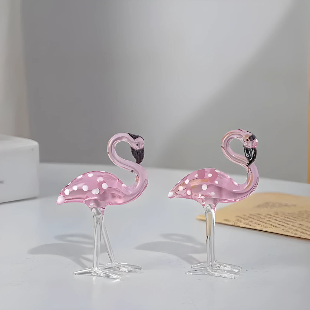 White crystal flamingo decorative ornaments with pink dots on a table