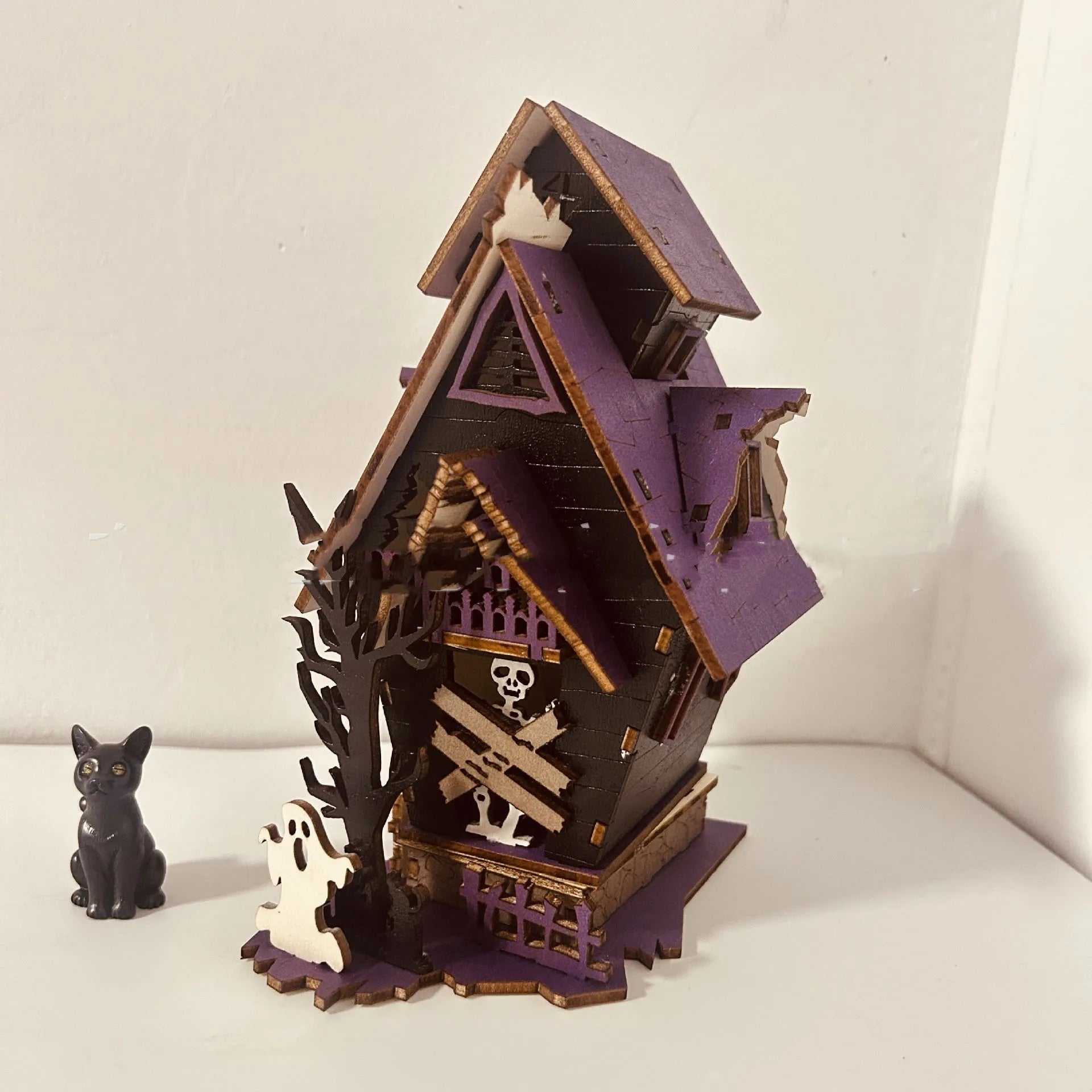 Wooden haunted house decoration with candlestick functionality measuring 14x10.5x19cm for Halloween table displays