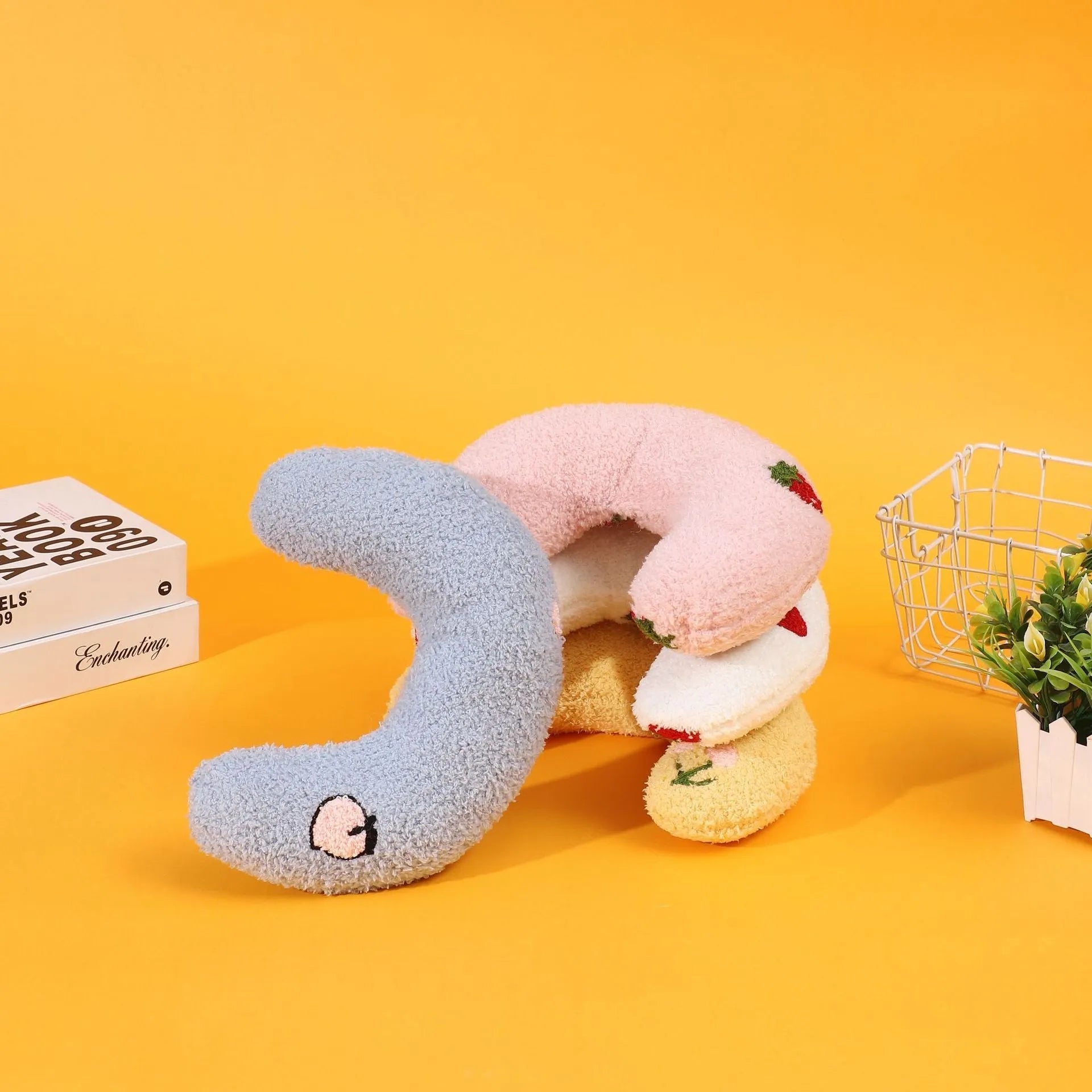 Blue half moon U-shaped cloth pillow for pets in a crate.