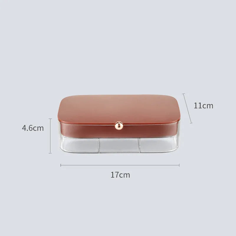Modern minimalist green jewellery storage box with multi-layer compartments open on a dressing table.