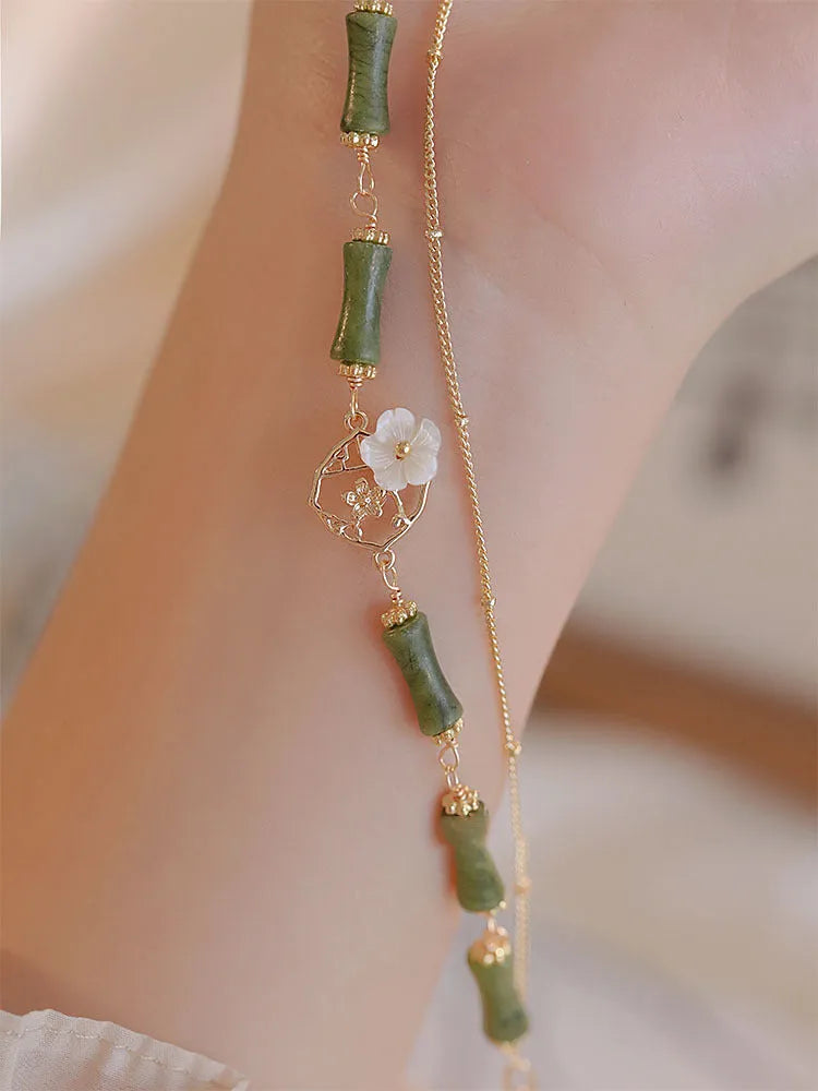 Natural green olivine bracelet with double layer design and Bells of Ireland charms