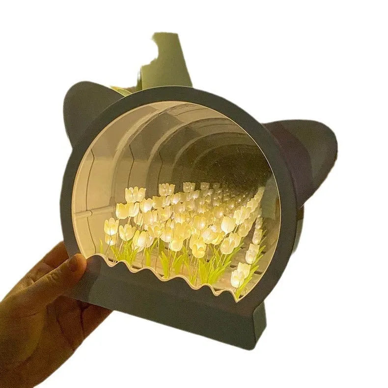 Handmade DIY cat head shaped night lamp with a sea of colourful tulip flowers, shown in pink.