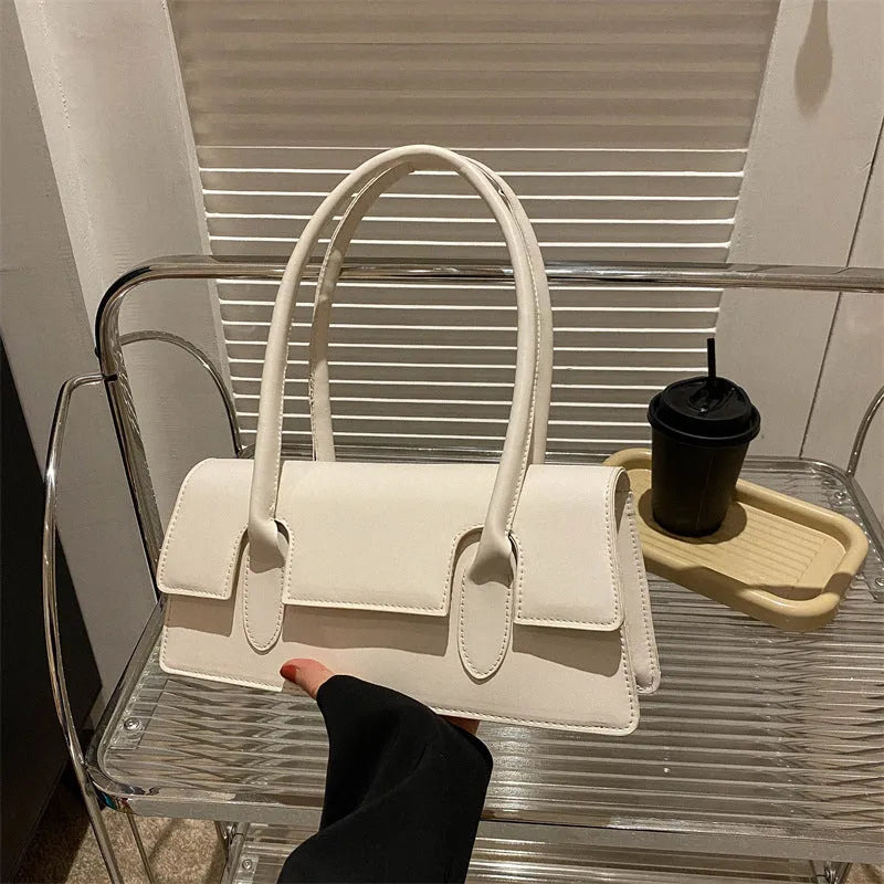 Women's retro style small square shoulder bag in four colours with adjustable strap and stitching detail