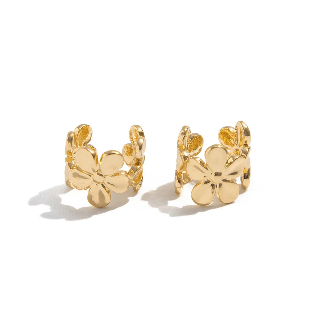 Gold starfish and conch shell earrings for women on a white background.