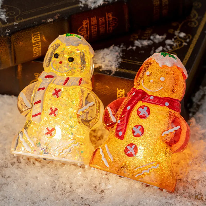 Glowing red-scarf gingerbread man Christmas ornament with modern design on a green tree branch.