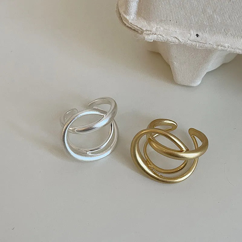 Three-dimensional interlaced geometric open ring in matte metal with gold plating