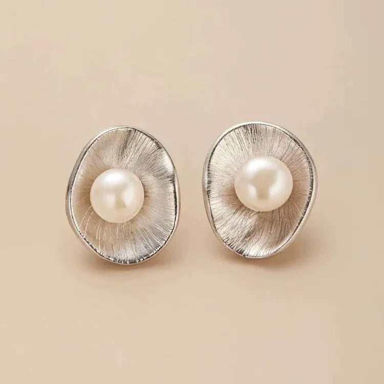 Pearl sterling silver needle earrings with geometric design elements in gold colour