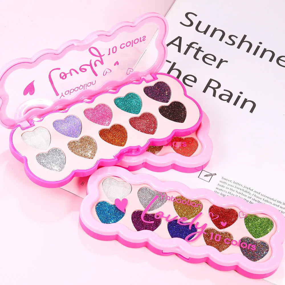 Pearlescent heart design eye shadow palette showing ten colours including white, beige, pink, purple, brown, blue, black, royal blue, maroon, and coral