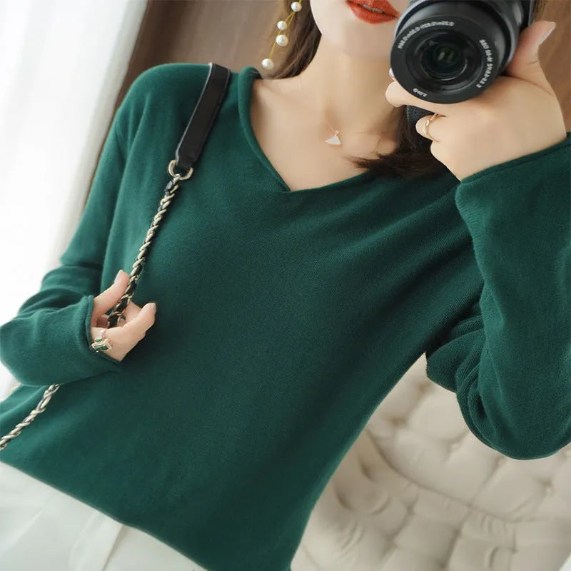 Women's V-neck long sleeve knitwear pullover top in a non-ironing material on a hanger.