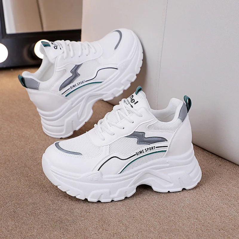 Women's white low-top dad shoes with cross straps and lace-up front
