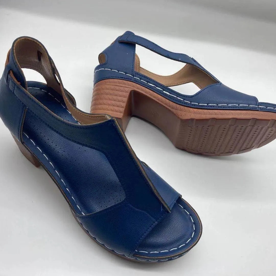 Women's white peep toe wedge sandals with a Roman style fish mouth toe and ankle buckle on a low rubber sole.