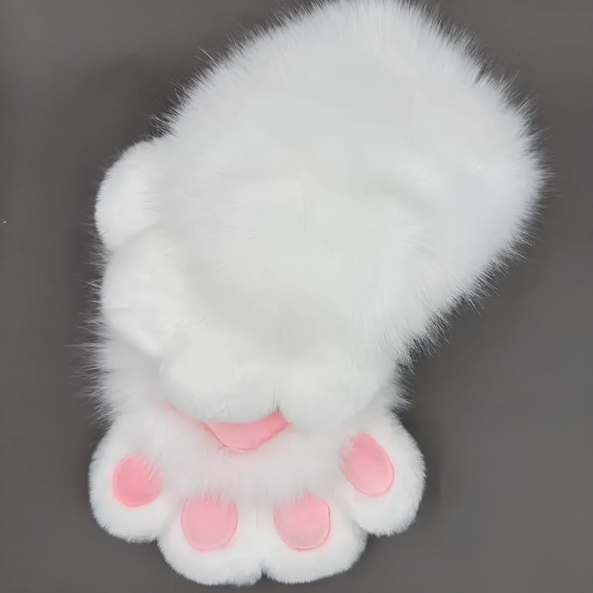 A pair of fingerless animal claw cosplay gloves in a white and pink colour combination with a coloured pad on the back.