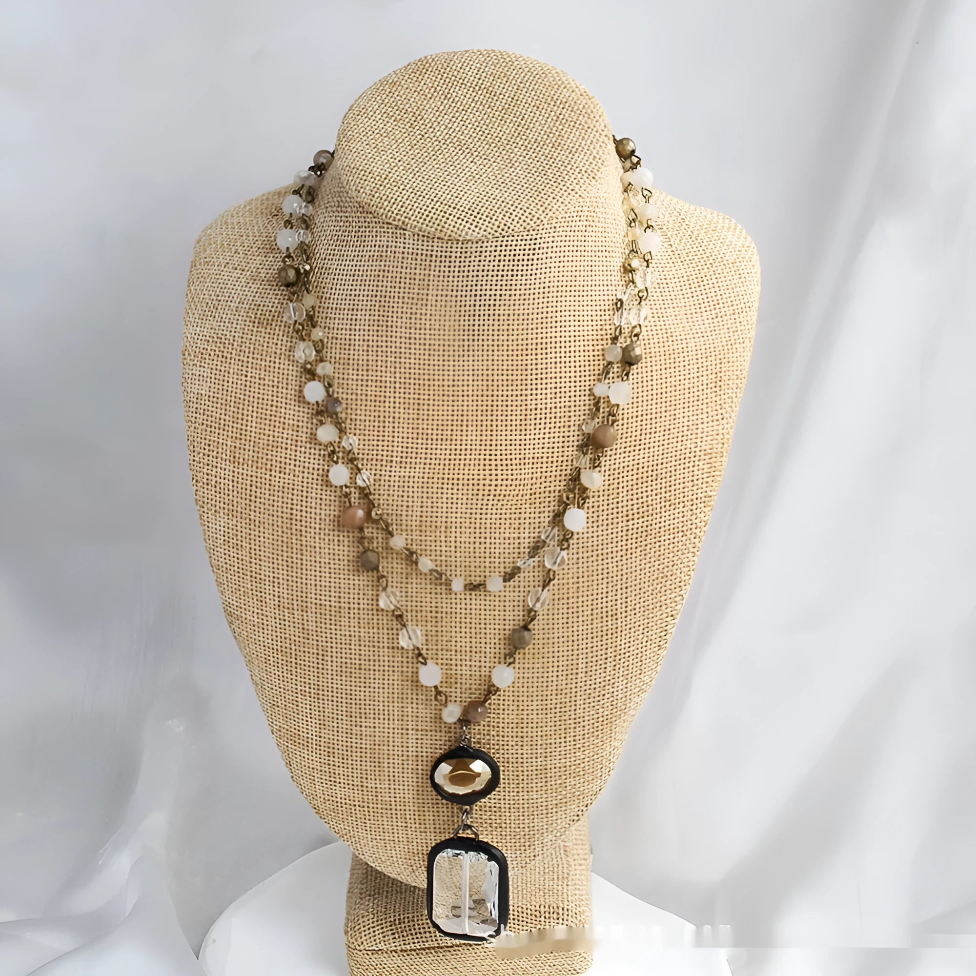 Tribal-style layered necklace with glass pendant and adjustable chain in beige or blue.