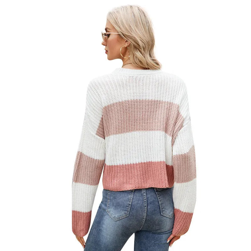 Women's pink and white striped loose fit short sleeve acrylic pullover on a hanger.