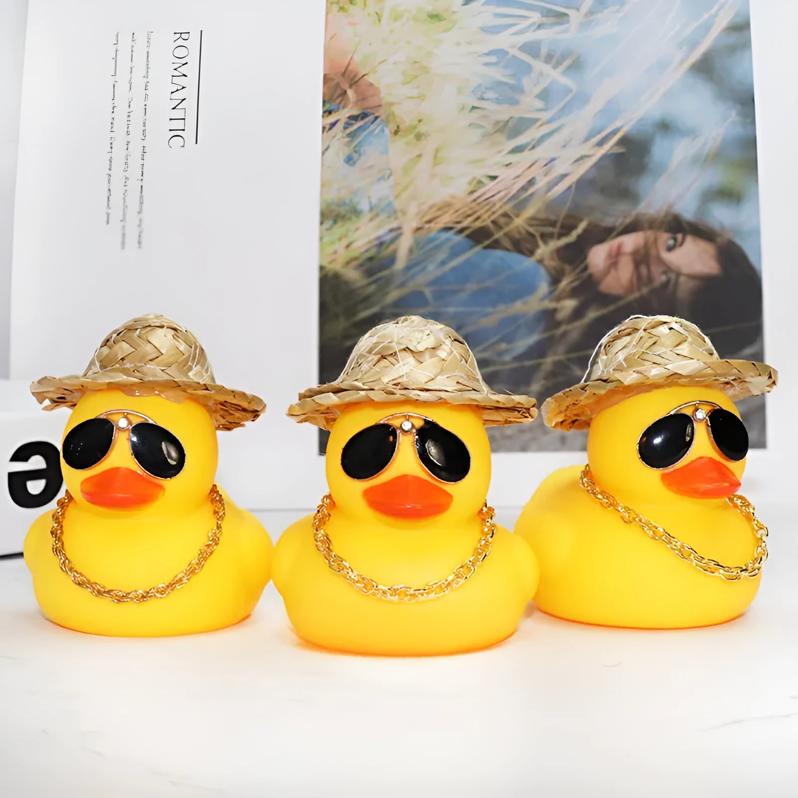 Cartoon yellow duck car ornament wearing a straw hat and sunglasses