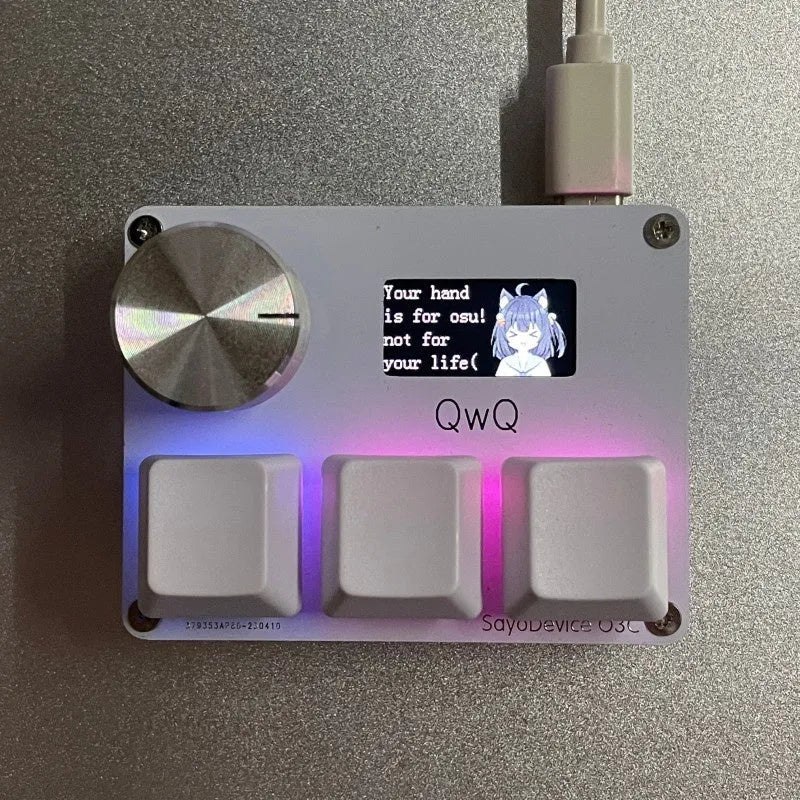 Customisable magnetic axis gaming keypad with programmable knob and colour IPS screen on desk.