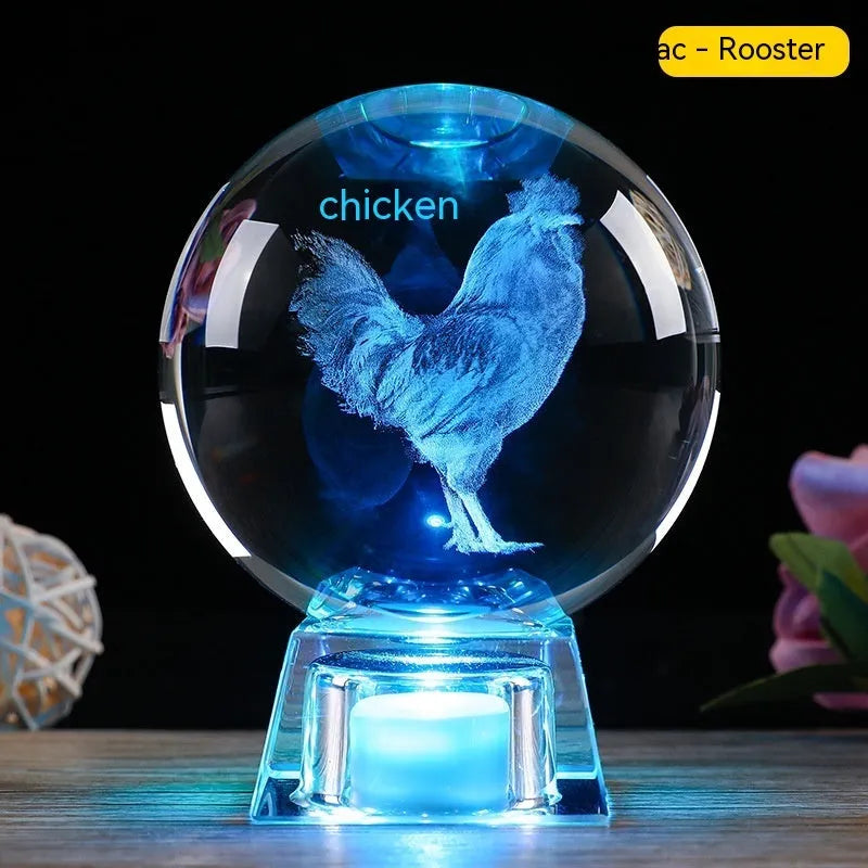 White crystal ball luminous ornament with Chinese zodiac animal design on an electronic charging base.