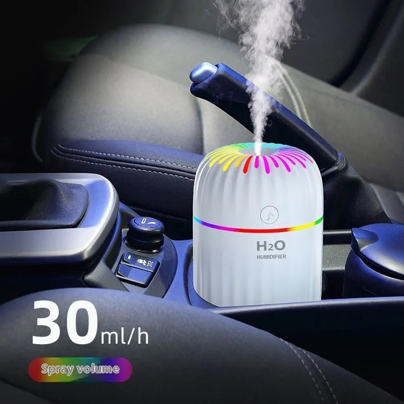 Mini USB-powered humidifier with animal design in green colour, showing compact size and data cable connection