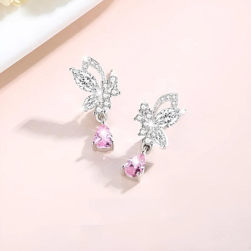 Close-up of women's butterfly stud earrings in sterling silver with clear rhinestone details.