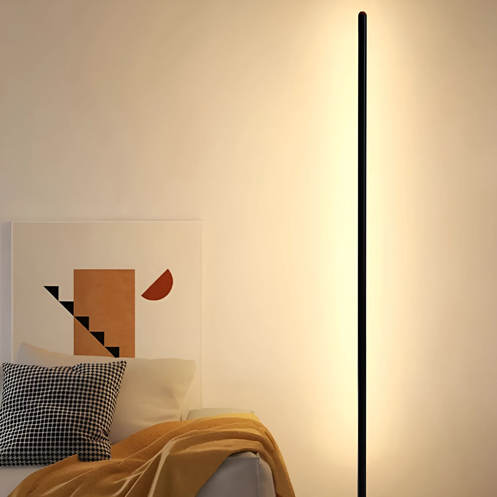 Vertical aluminium alloy floor lamp with a simple modern design, shown in a living room setting.