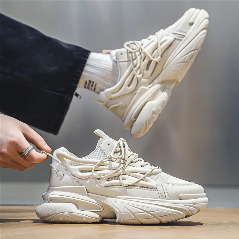 Men's beige and black low-top lace-up sneakers with mesh upper and rubber platform sole.