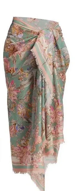 Creamy-white women's floral print bikini set with matching skirt on a hanger.