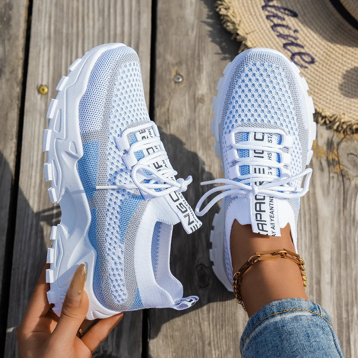 Women's Flyknit mesh lace-up sneakers in a selection of colours, showing round toe and flat rubber sole.