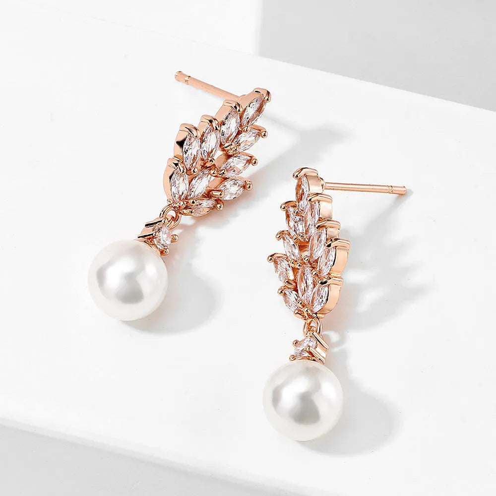Geometric flower design pearl earrings with micro inlaid zircon stones in gold, platinum, or rose gold plated finishes.
