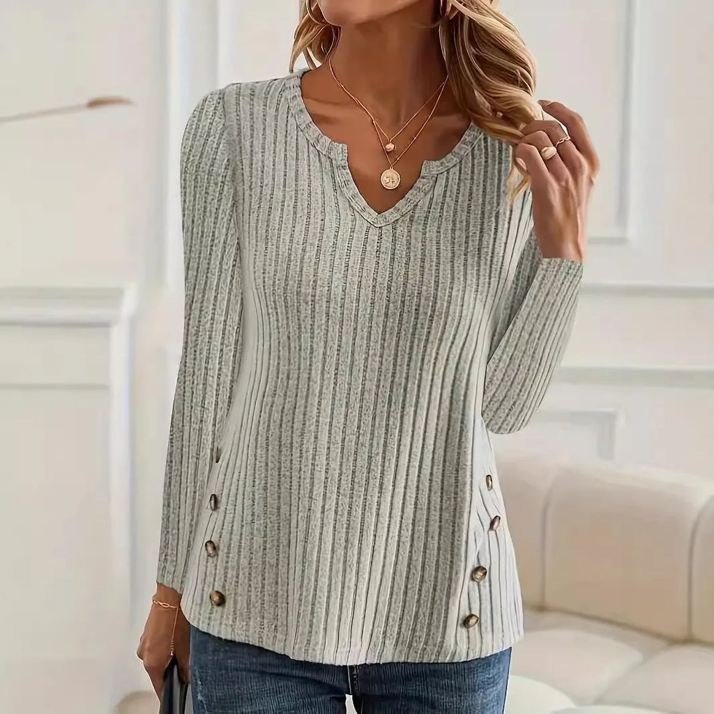 Women's black knitted pullover sweater with a button detail on the front.