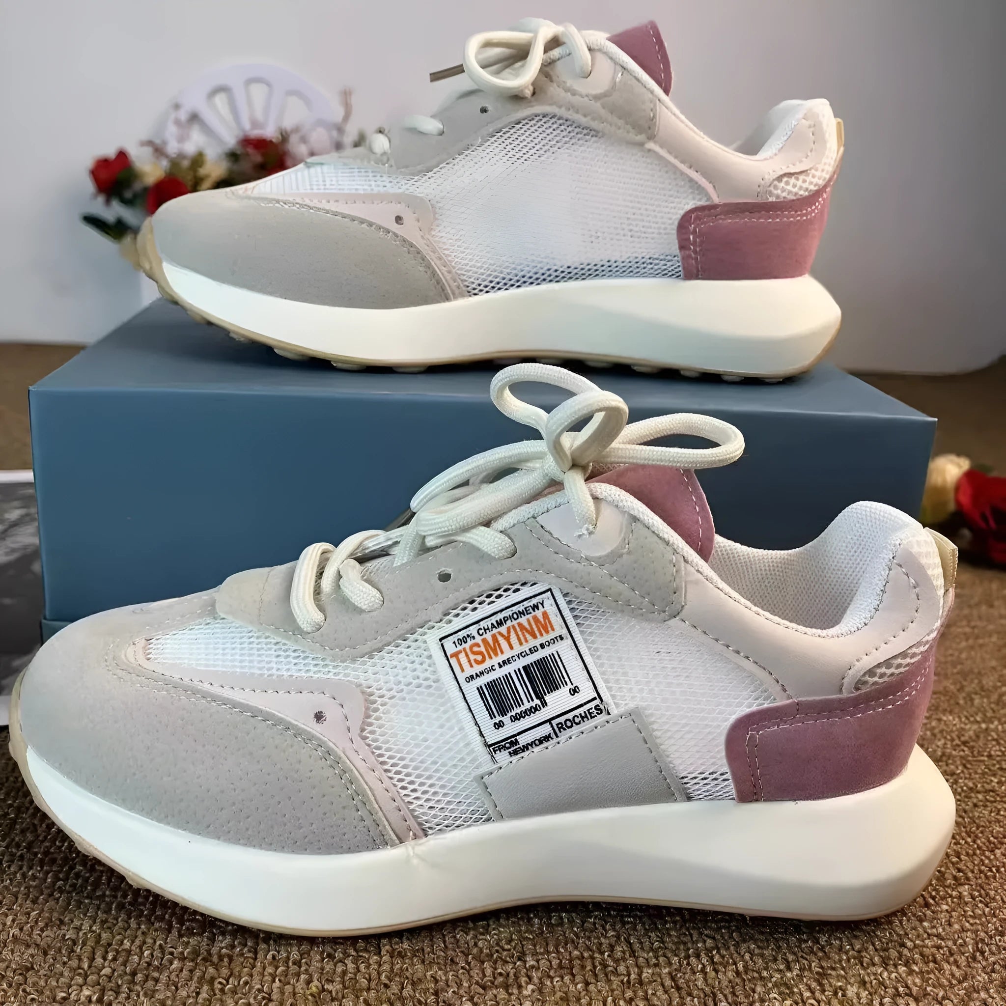 Women's gray and pink retro sneakers with mesh lining, rubber sole, and low-top design