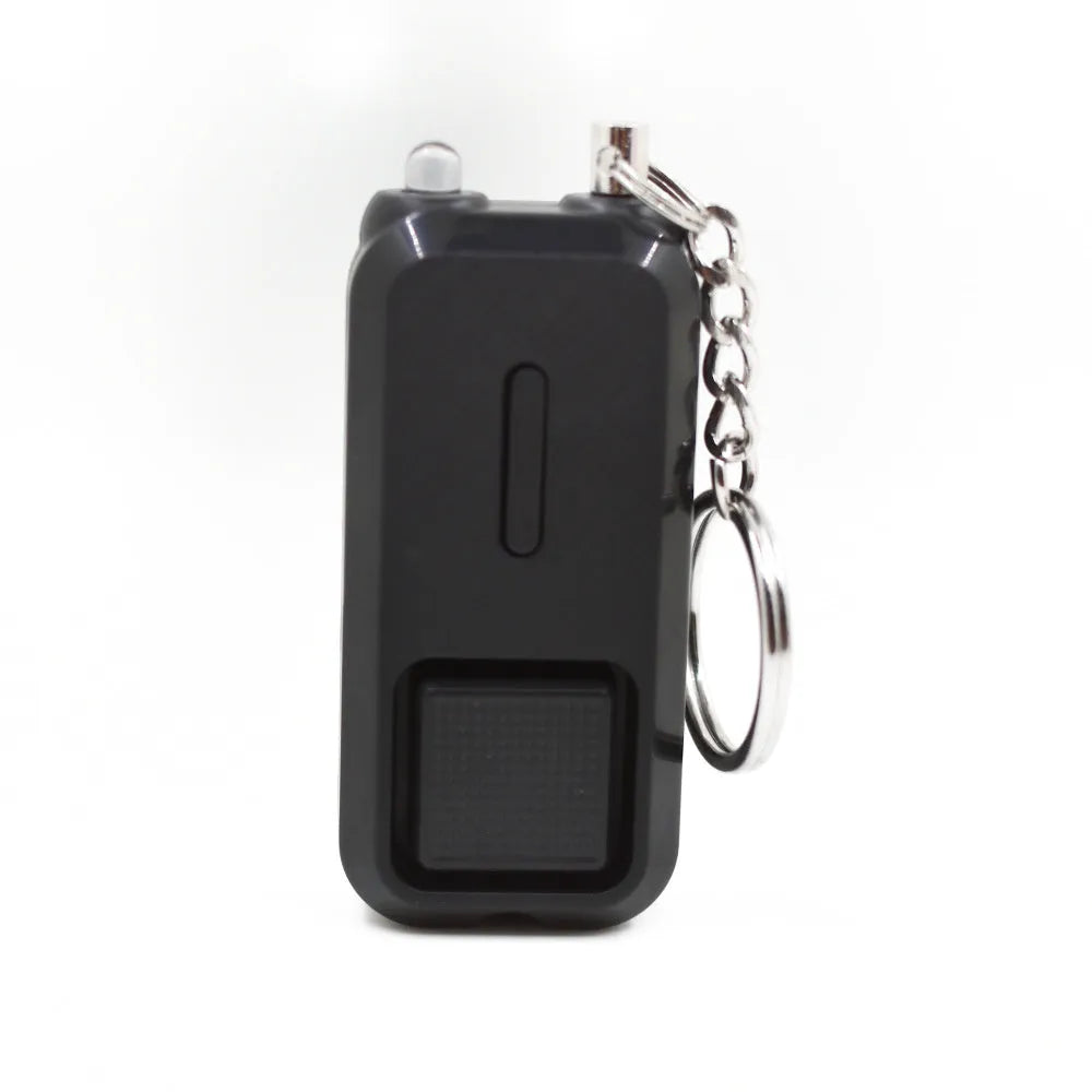 Pink personal security alarm showing compact size next to LR44 batteries