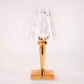 Rose gold portable touch projection night light with acrylic lamp holder on wooden surface