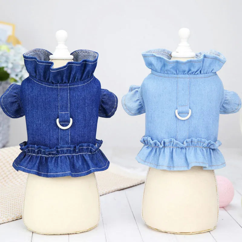 Blue denim dog dress with a ruffled vest design and a metal leash hook on the chest.