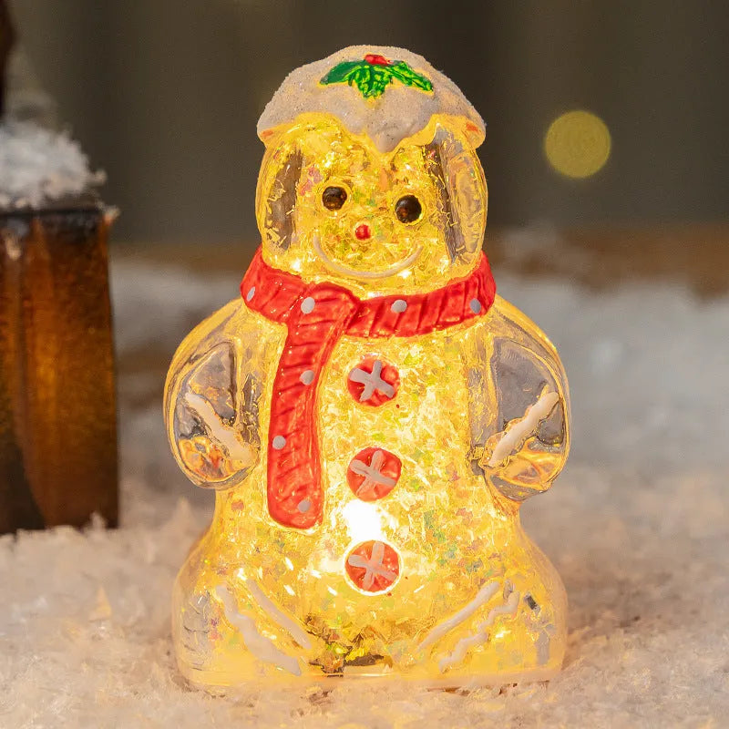 Glowing red-scarf gingerbread man Christmas ornament with modern design on a green tree branch.