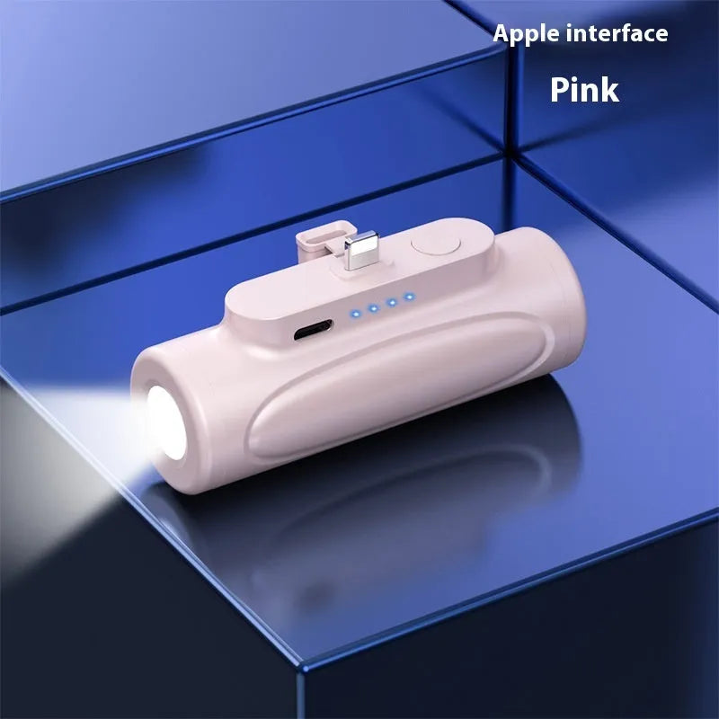 Black and pink creative power bank with integrated LED flashlight, showing USB-C and Apple port options.