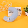 Blue half moon U-shaped cloth pillow for pets in a crate.